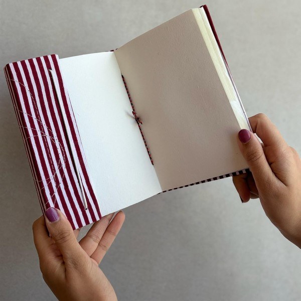 The inside pages of a striped notebook, sustainable art paper.